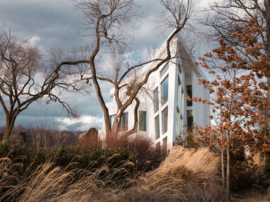 This contemporary home provides unique views with the teardrop-like shape that juts out into the landscape.