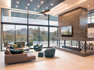 A wall of glass makes the Arizona desert the main focus of this home’s living room.