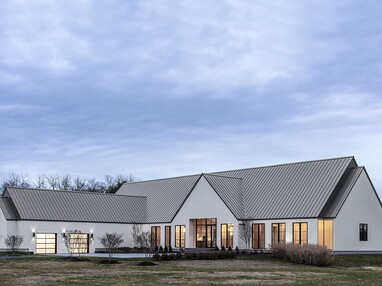 The home takes advantage of its position along the Wye River with tall glass windows and doors along the home’s façade.