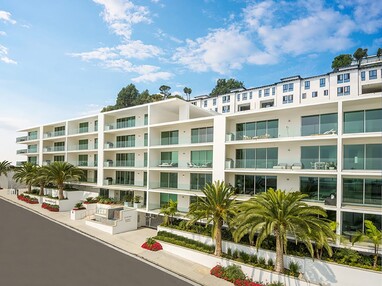 A five-story condo-complex with sliding glass leading to the balcony for every condo.