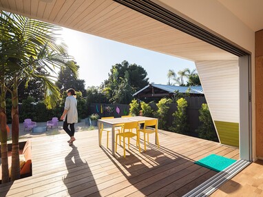 A large multi-slide door eliminates the home’s barrier to the backyard patio