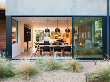 A massive multi-slide door connects the kitchen to the backyard.
