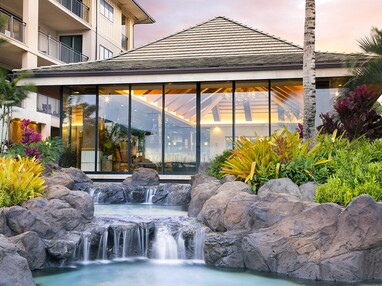A beautiful view of multi-slide doors behind a small, man-made waterfall.