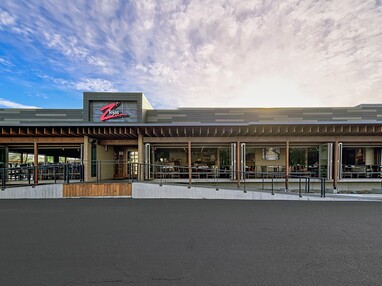 A front view of the restaurant completely opened up through bi-fold doors.