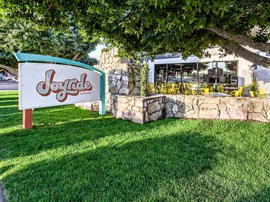 A view of the restaurants patio and sign.
