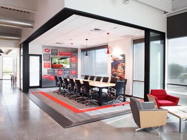 A 90-degree multi-slide door seamlessly merges this conference room with the Western Window Systems lobby area.