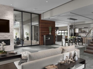 A large, 3-panel multi-slide door connects the living room to the covered outdoor seating area.