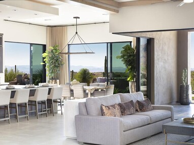 Multiple floor-to-ceiling sliding glass doors open to envelop the indoor living space with a seamless view of a mountain landscape.