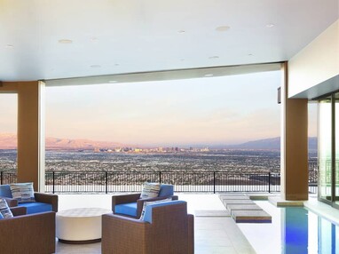The walls of glass in this home completely disappear to provide uninterrupted views of Las Vegas.