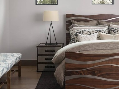 Fixed bedroom windows sit above the bed, inviting natural light into the room.