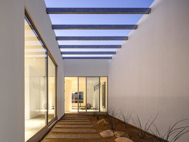 Massive sliding glass doors lead to enclosed courtyards for the cats to roam around in.