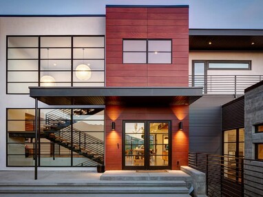 Both stories of the home provide grand views through large windows and glass doors.