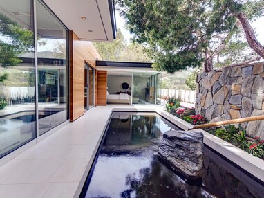Large openings and panes of glass without connecting posts give homes a seamless connection between the indoors and the outside.