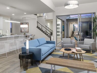 A contemporary-styled living space is connected to the outdoors with a tall multi-slide glass door.