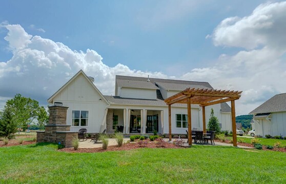 A close view of a shaded outdoor seating area with a multi-slide glass door in the background.