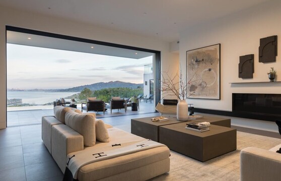 Living room with multi-slide doors tucked away revealing the San Francisco Bay view.