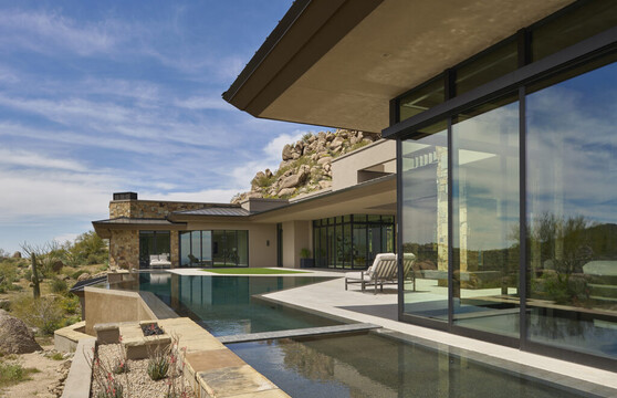 Exterior view of the backyard and sliding glass doors of a custom home.