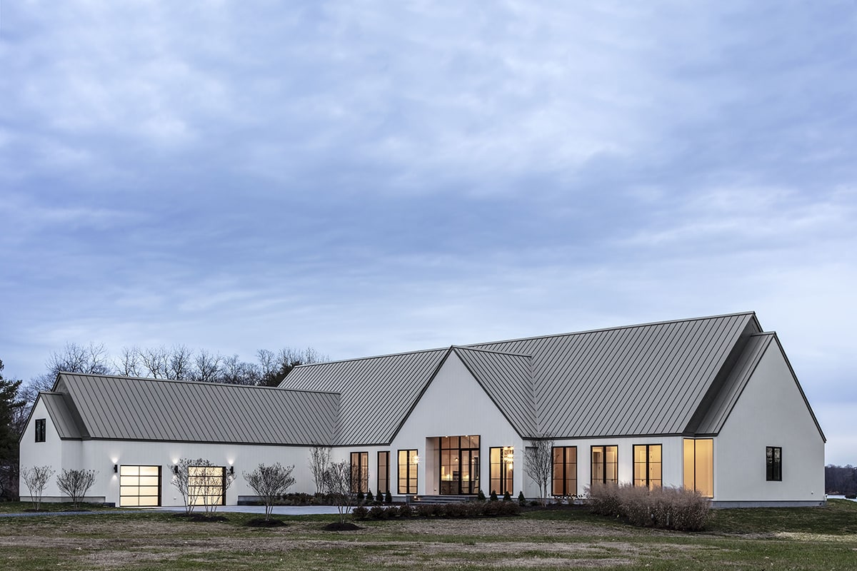 The home takes advantage of its position along the Wye River with tall glass windows and doors along the home’s façade.