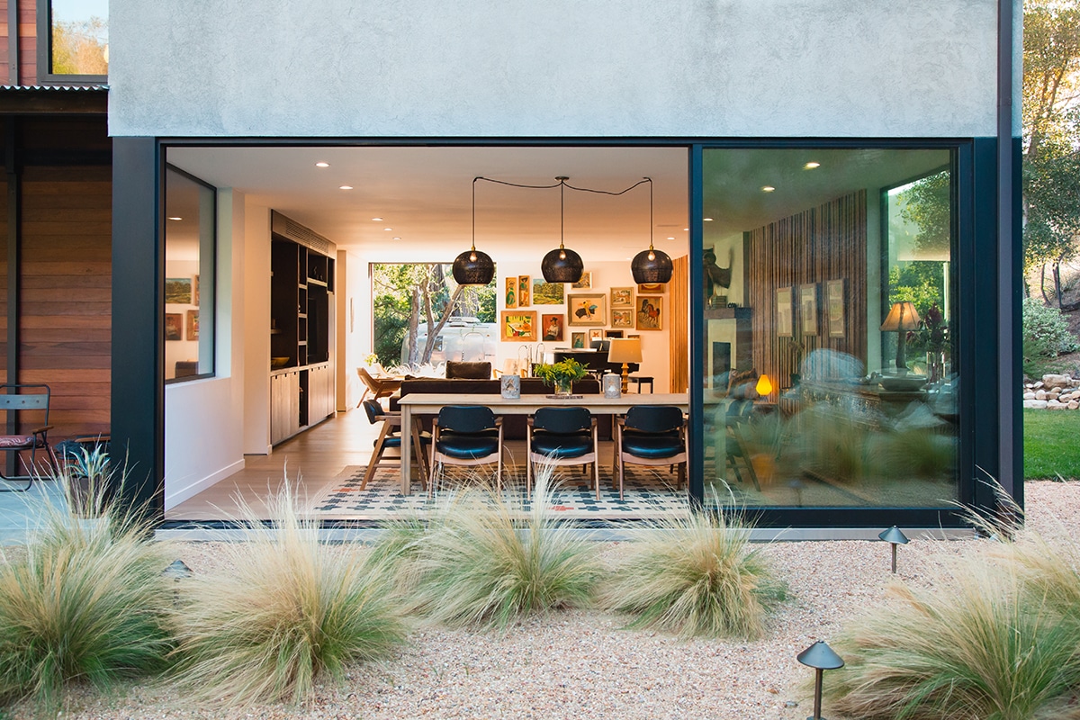 A massive multi-slide door connects the kitchen to the backyard.