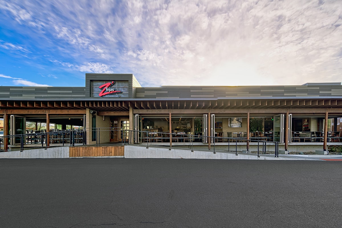 A front view of the restaurant completely opened up through bi-fold doors.