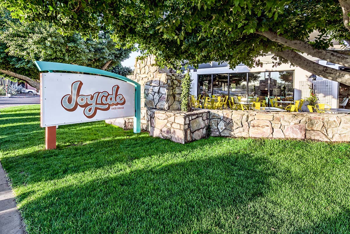 A view of the restaurants patio and sign.