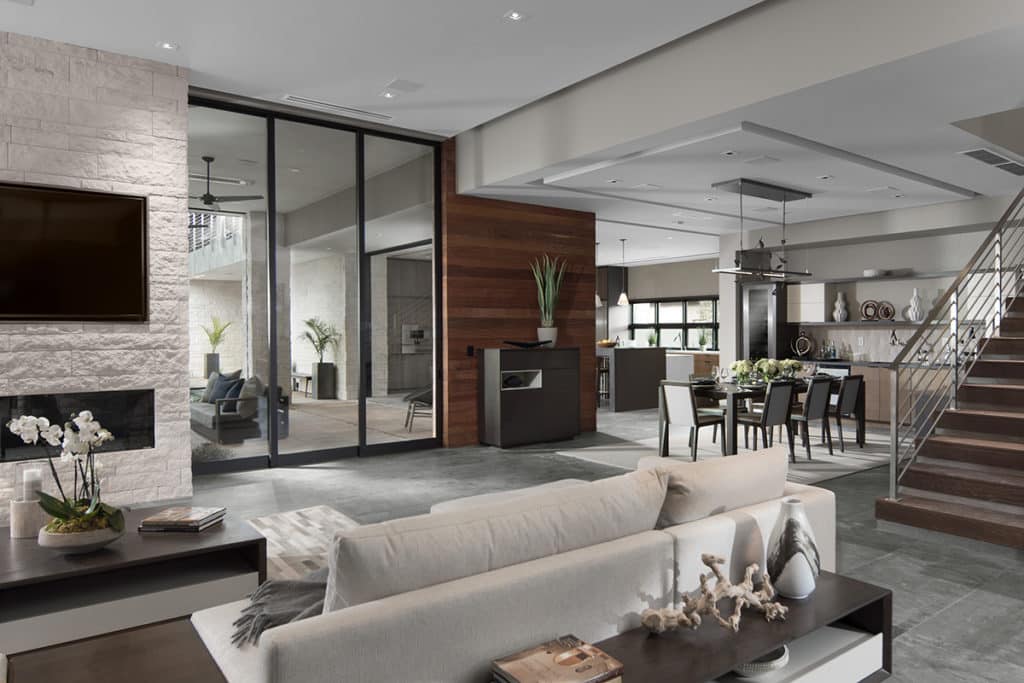 A large, 3-panel multi-slide door connects the living room to the covered outdoor seating area.