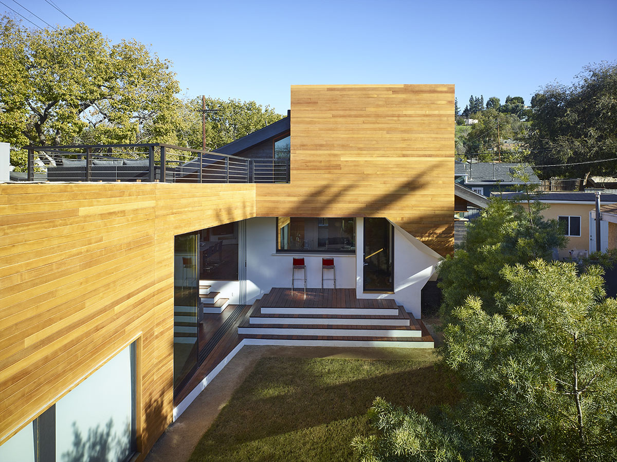 The indoor sitting space extends to the backyard through a large sliding glass door.