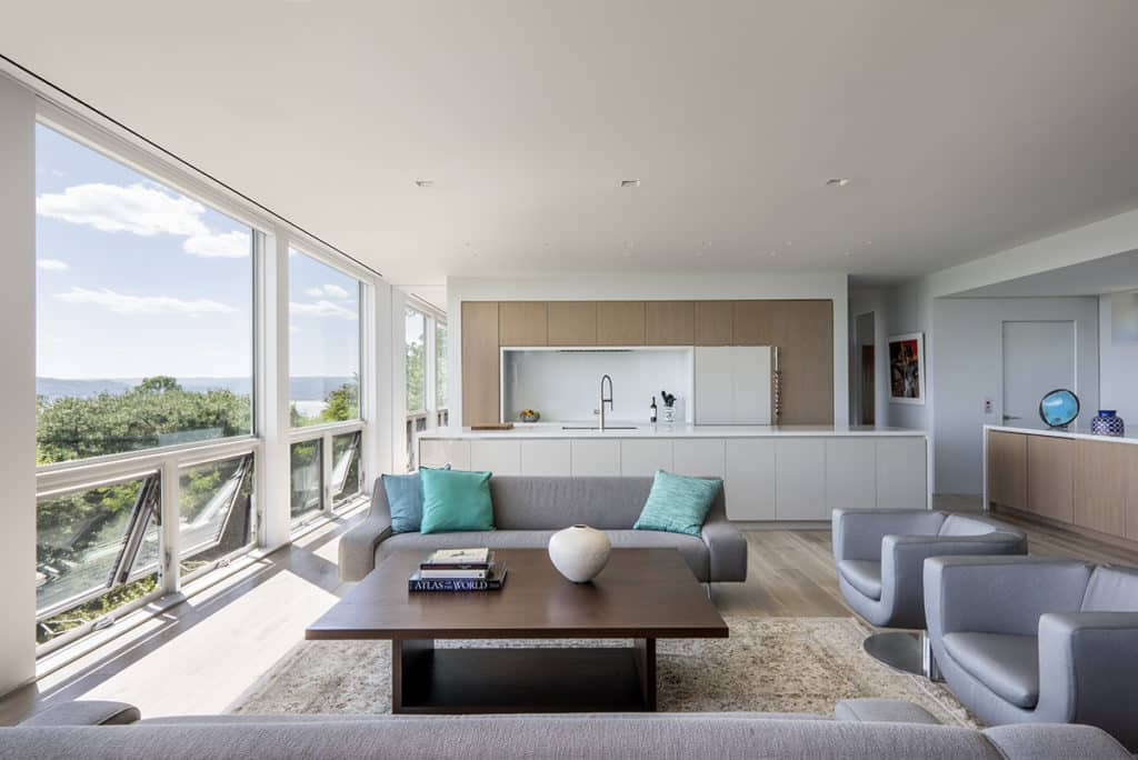 Large fixed and operable windows bring natural light into the living room and kitchen.