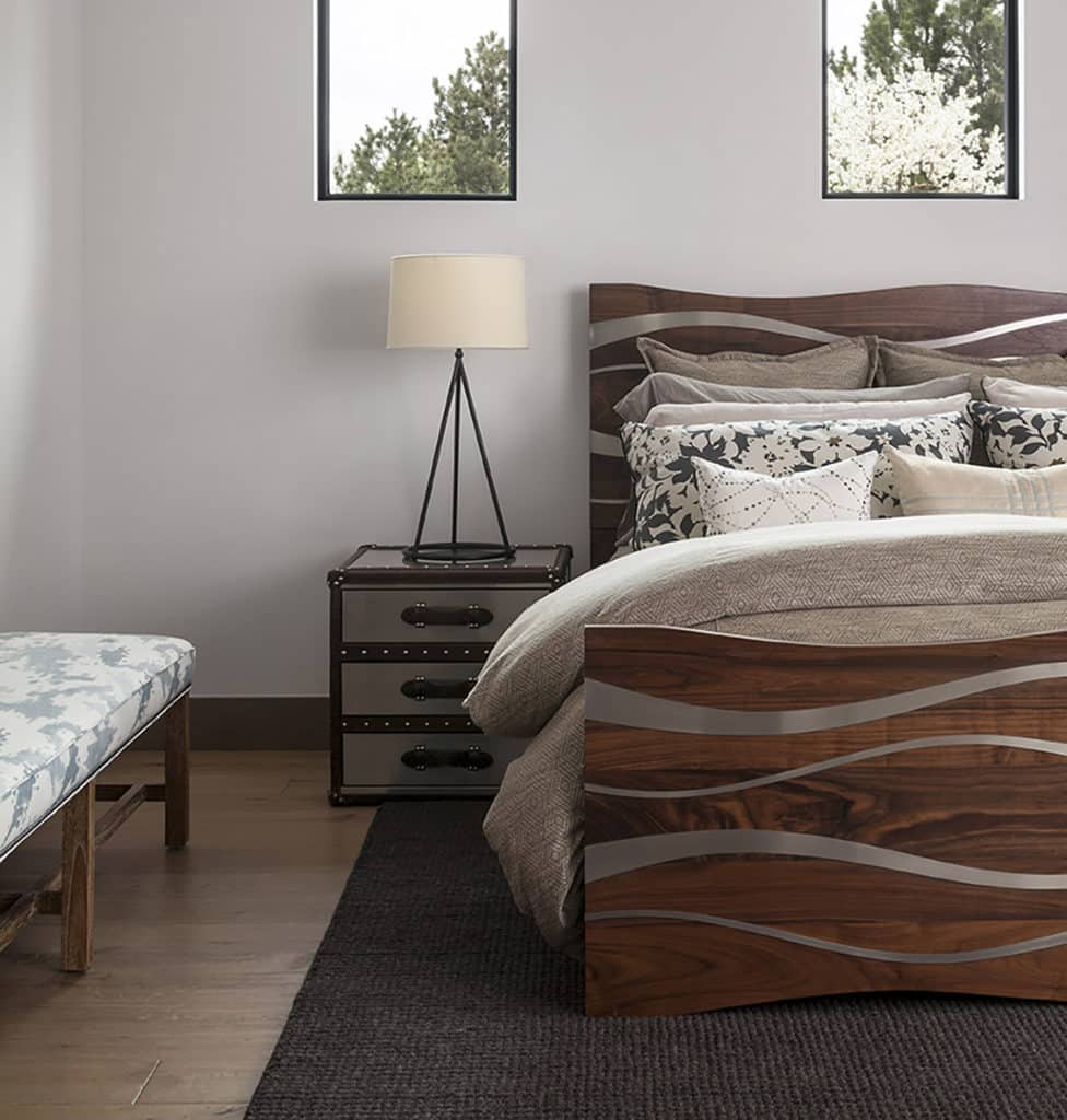 Fixed bedroom windows sit above the bed, inviting natural light into the room.