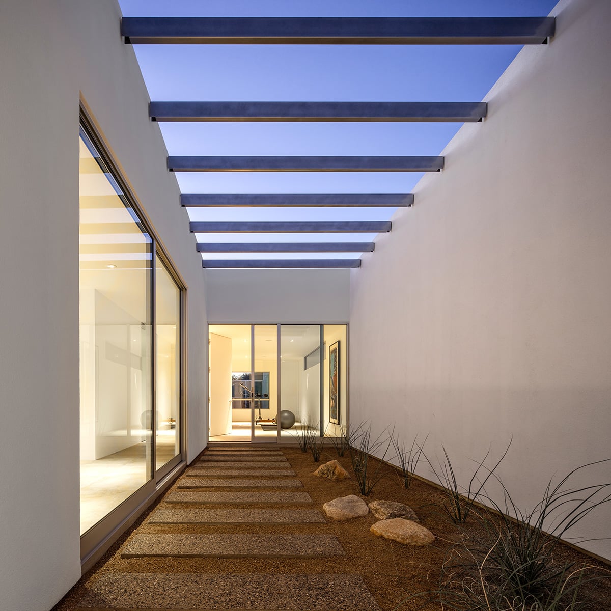 Massive sliding glass doors lead to enclosed courtyards for the cats to roam around in.