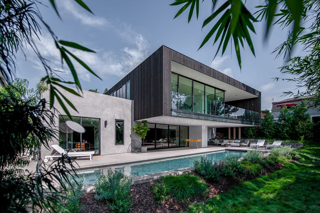 A view of the balcony with a large glass wall that opens to the patio.