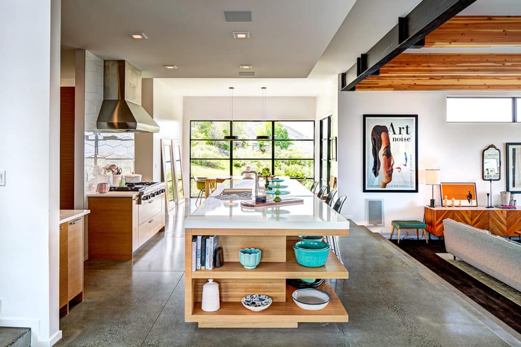 The strategic placement of two window walls and floor-length mirrors allow for this kitchen to be flooded with light.