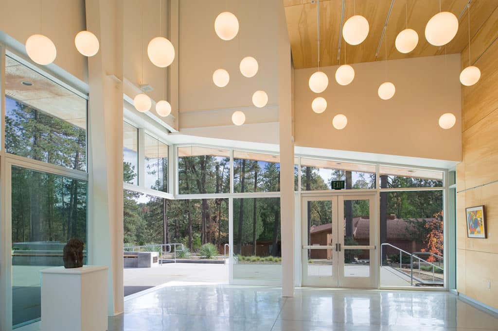 A Series 600 90-Degree Multi-Slide door opens the lobby to the outside.
