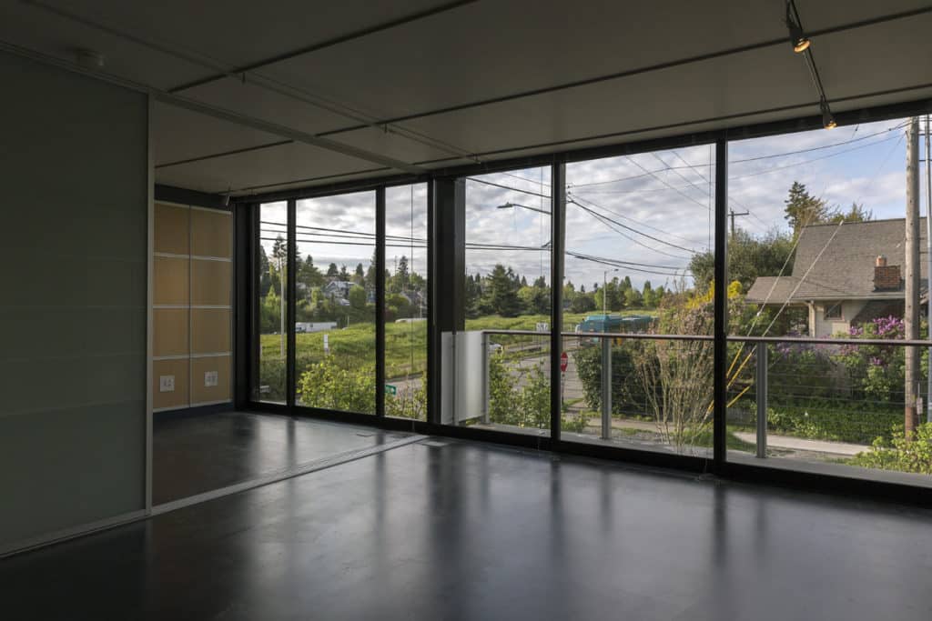 Series 600 Multi-Slide Doors open onto outdoor decks in the apartments while framing views of the green landscape.