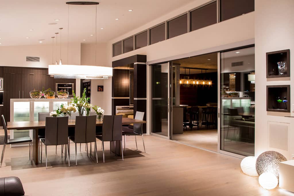 Two large sliding doors seamlessly merge the kitchen with a fully outfitted outdoor living space.