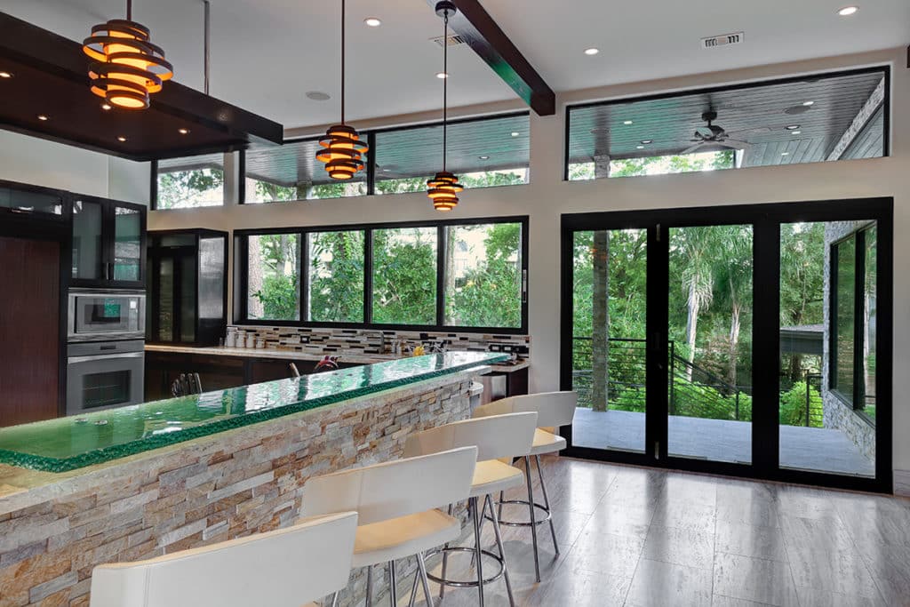 The beautiful kitchen features not only a stacking bi-fold door, but also a multi-slide window to increase the home's indoor-outdoor possibilities.