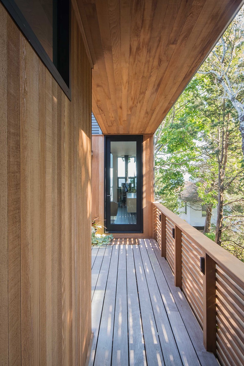 A hinged glass door provides a view into the interior of the home from the balcony.