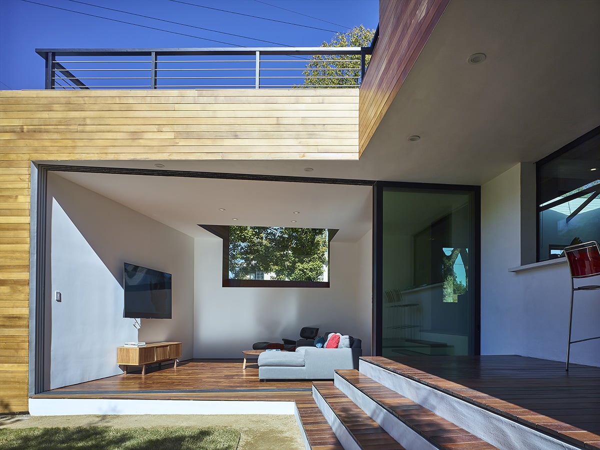 The living room has an indoor-outdoor feel thanks to the large sliding glass door.