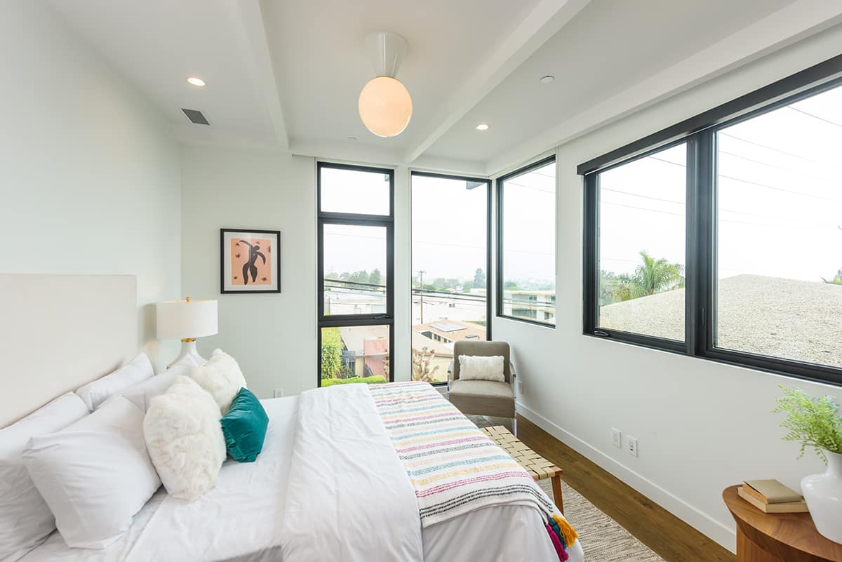 This bedroom features an array of shapes and sizes of big glass.