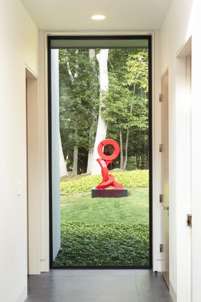 Windows and doors throughout this home frame works of art, making them the central focus in every room.