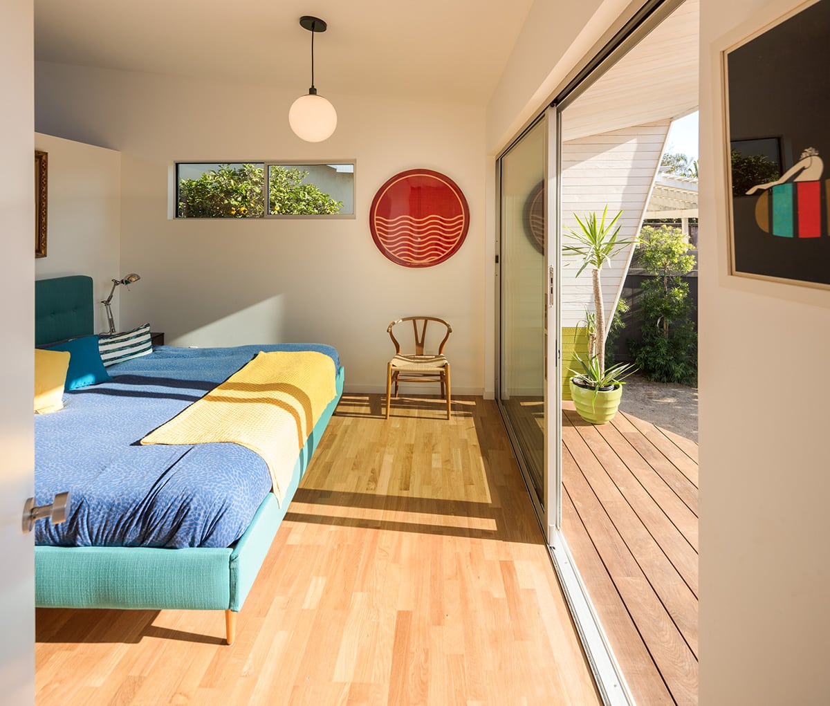 A large Series 600 Sliding Glass Door lets tons of natural light into the master bedroom.