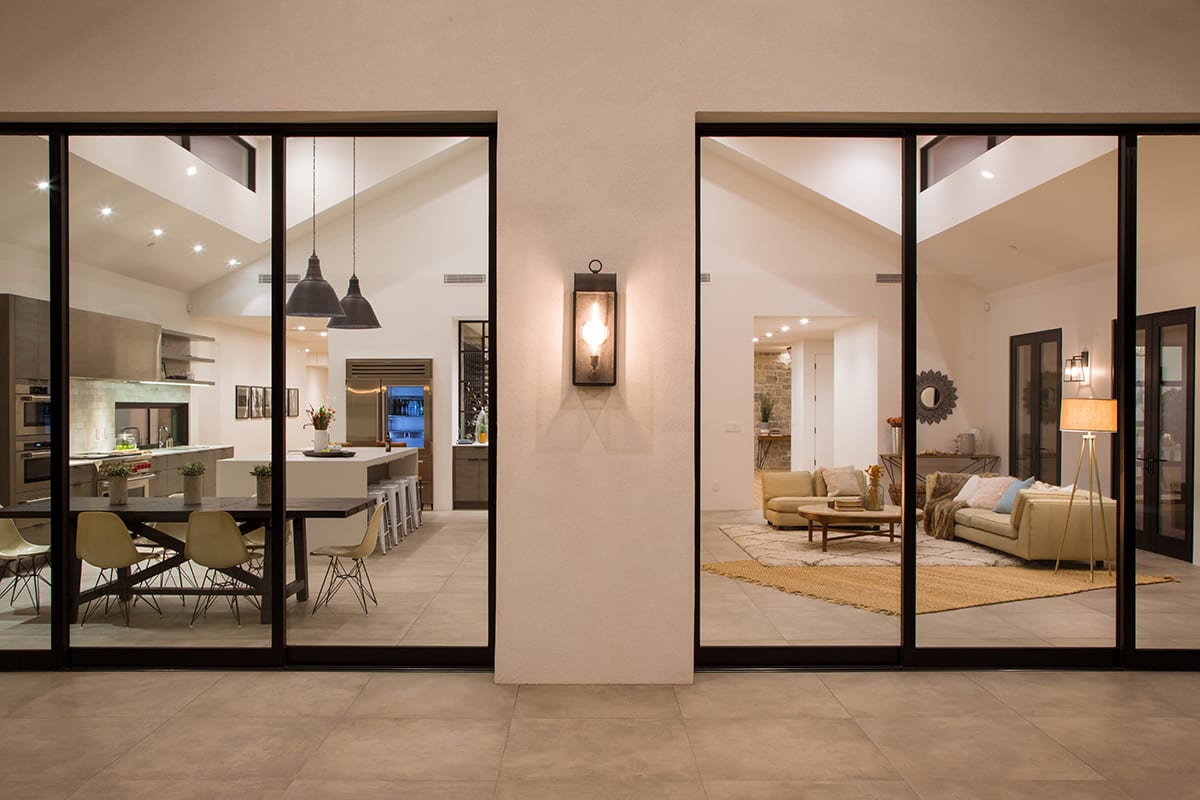 With the two multi-slide doors opened, the kitchen, dining, and living space becomes one with the outdoors.