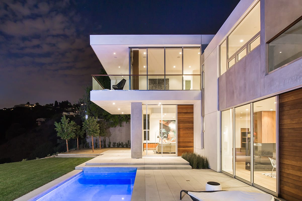 Both stories of the home embrace the use of multi-slide doors to connect to the outdoors.