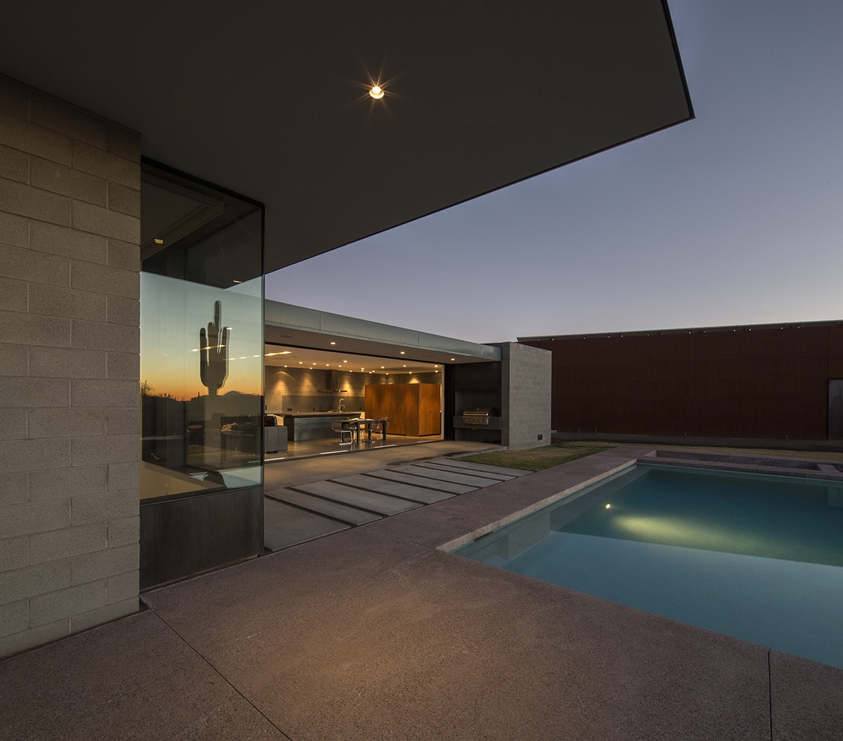 The indoor living area completely opens to the pool when the multi-slide door is open.