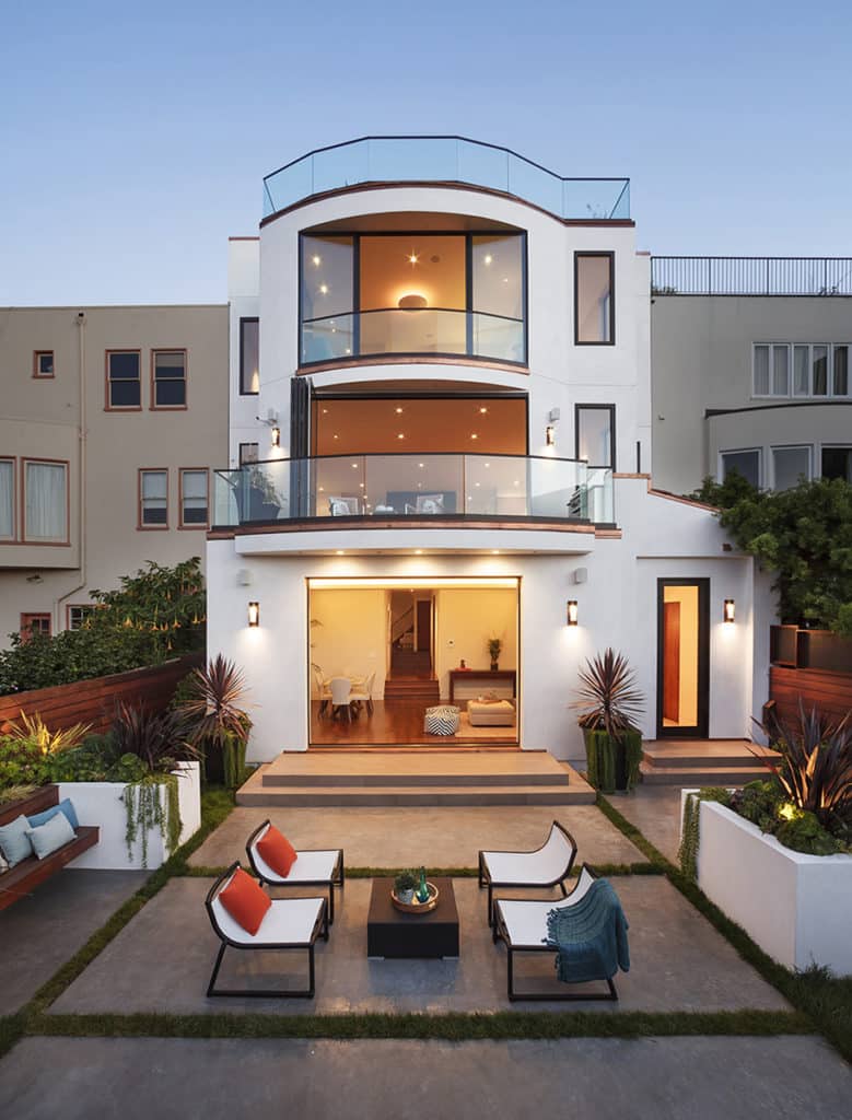 All three floors of the Spanish Revival home incorporate large glass doors to connect to the outdoors.