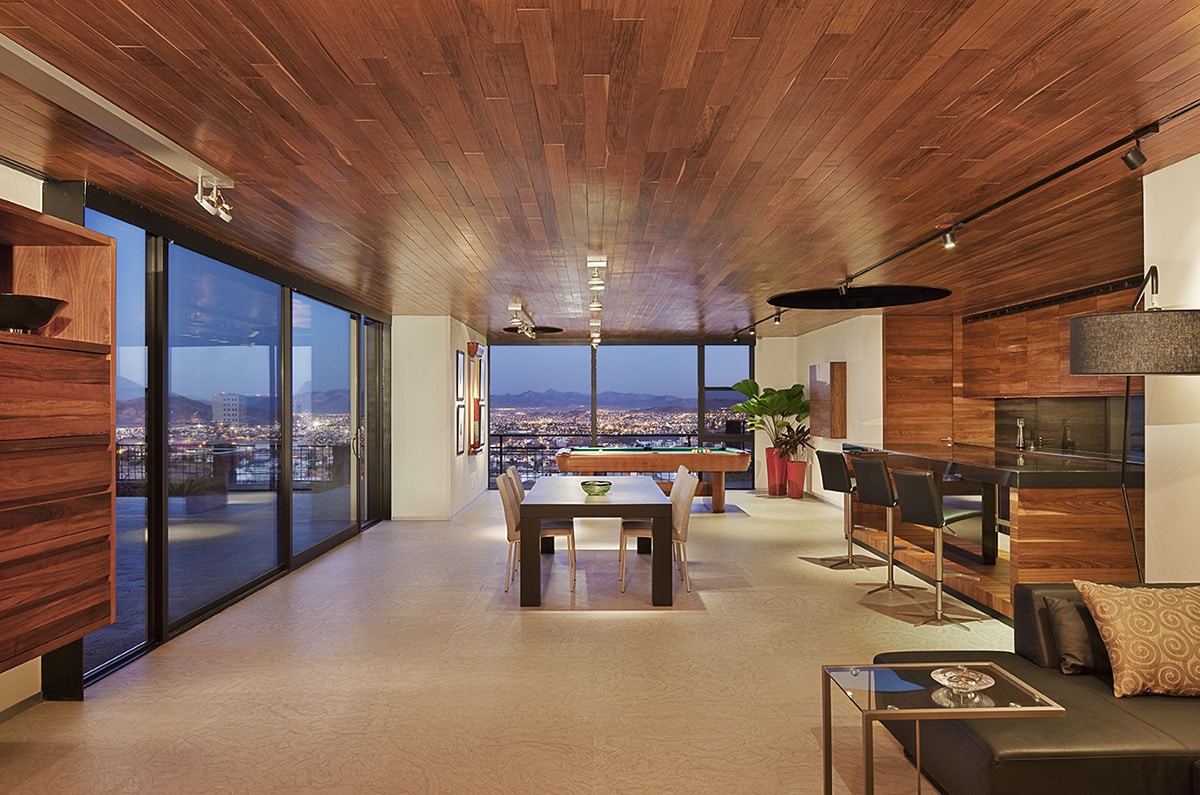 This dining and bar area has an air of elegance, courtesy of Western Window Systems walls of glass that frame views of the city below.
