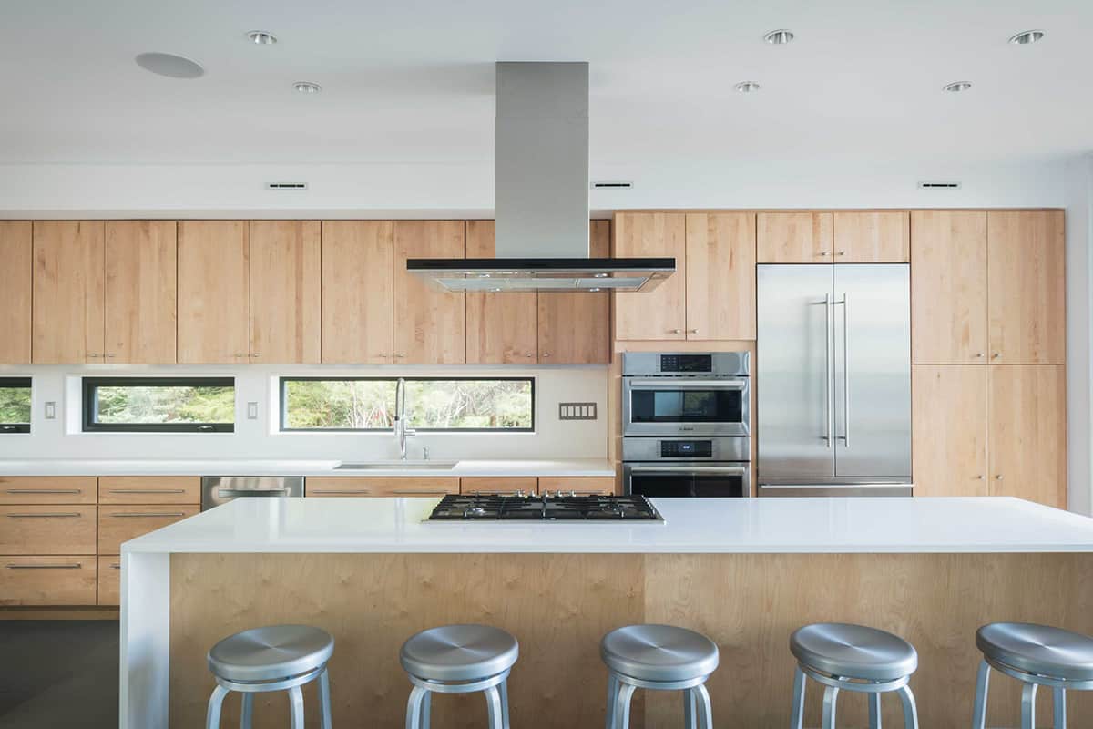 Fixed and operable windows over the counters let light into the kitchen.