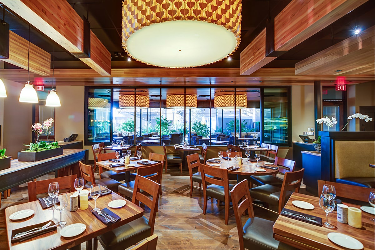 The multi-slide window provides an uber-contemporary appearance to the dining room, complementing the traditional dining room.
