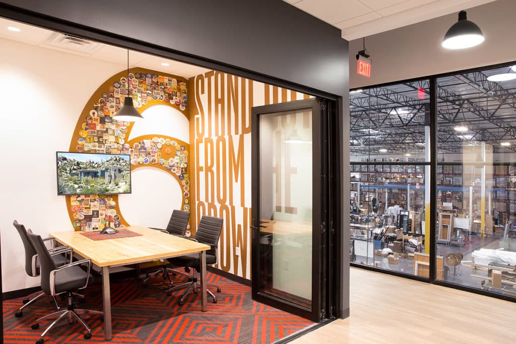 A bi-folding door stacks neatly to the side in one of Western Window Systems' mini conference rooms.