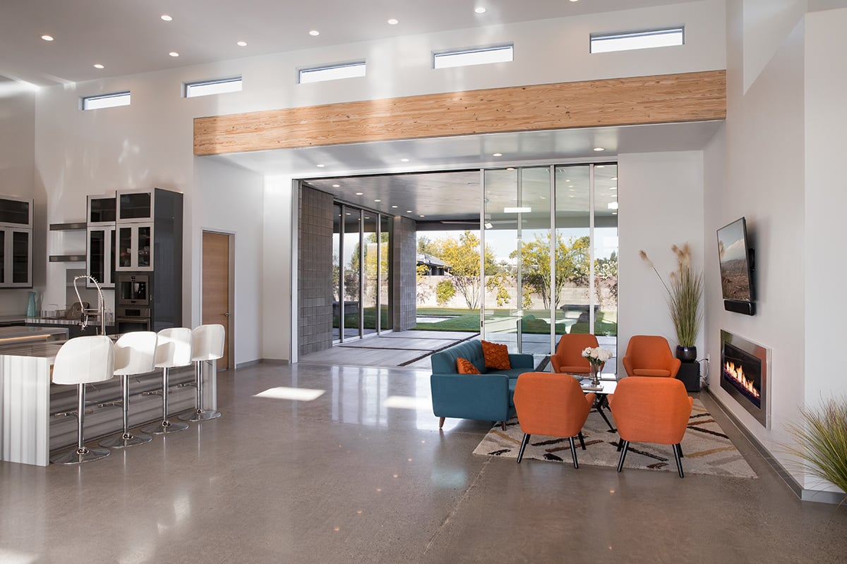 The five-panel multi-slide door connecting the living room and kitchen to the backyard is motorized for ultimate ease of use.